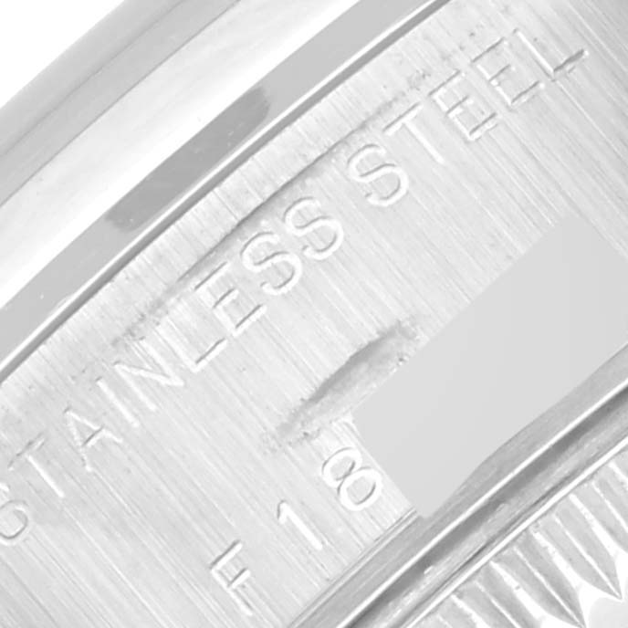 This close-up angle shows the engraved text "STAINLESS STEEL" on the side of a Rolex Date 79160 Women
s Stainless Steel White Dial 79160 Women
s Stainless Steel White Dial model watch case.
