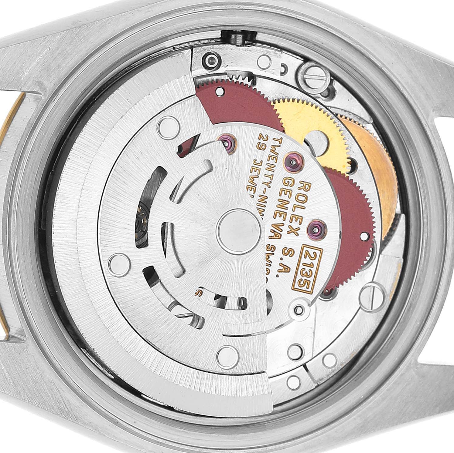 The image shows the movement mechanism of a Rolex Datejust 69173 Women's Steel and Gold (two tone) Champagne Dial watch from a back angle, highlighting gears and inscriptions.