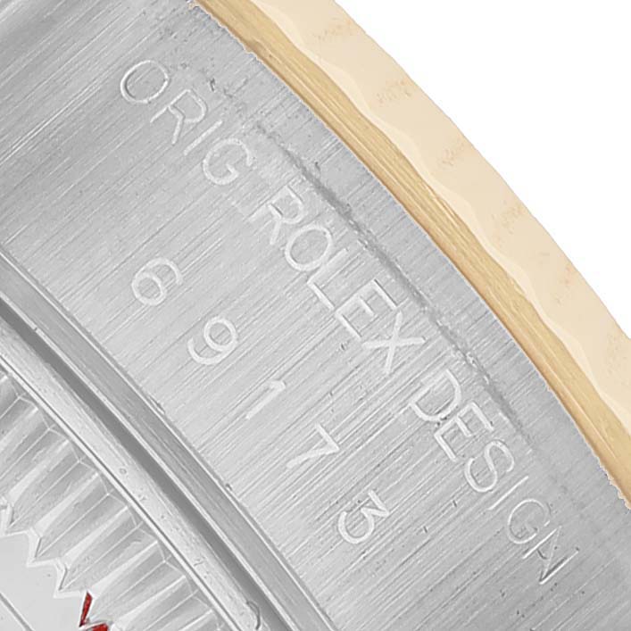 The image shows a close-up of a Rolex Datejust 69173 Women's Steel and Gold (two tone) Champagne Dial casing, highlighting engraved model details on the side.