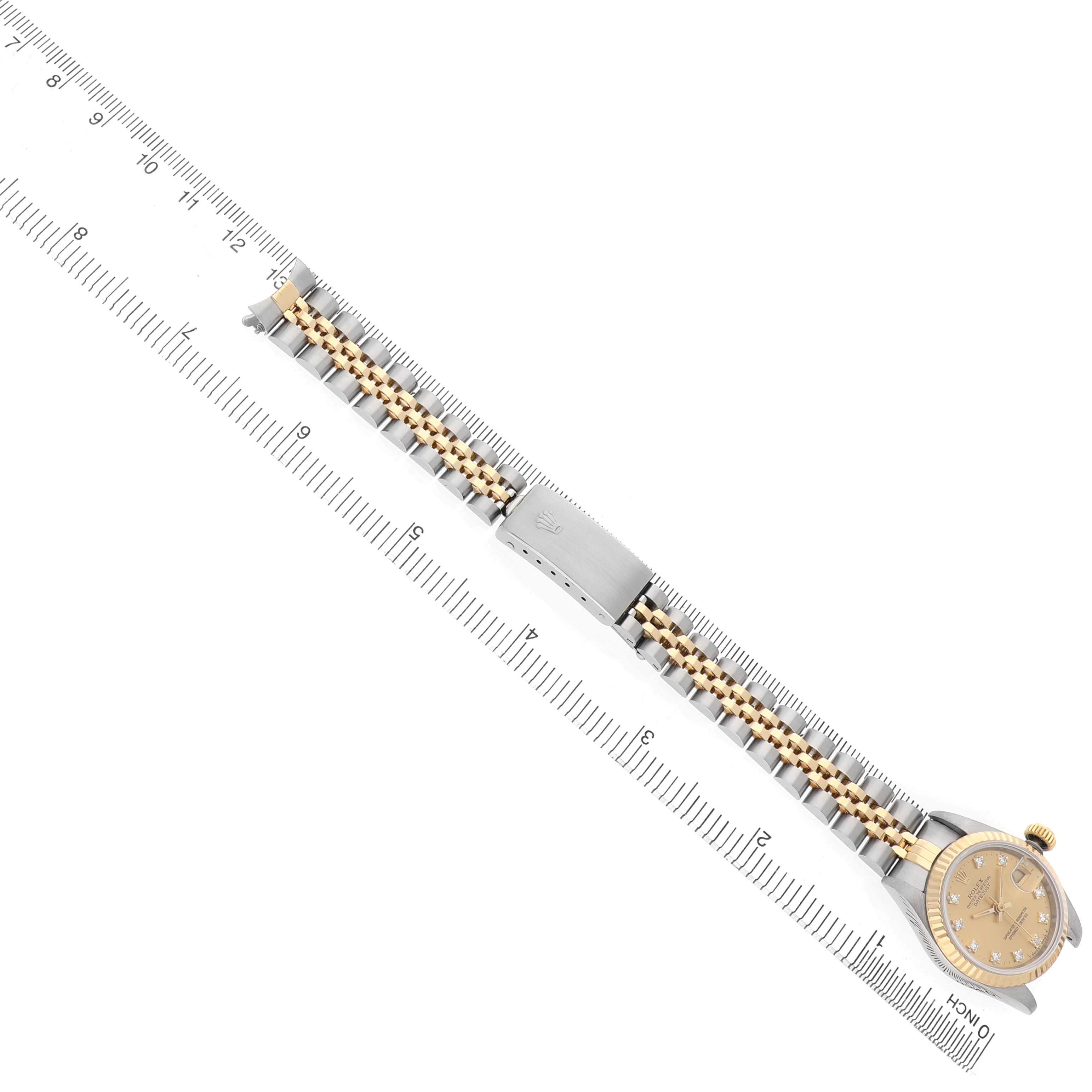 The image shows a Rolex Datejust 69173 Women's Stainless Steel Champagne Dial watch laid flat with its bracelet and clasp visible, alongside a ruler for scale.