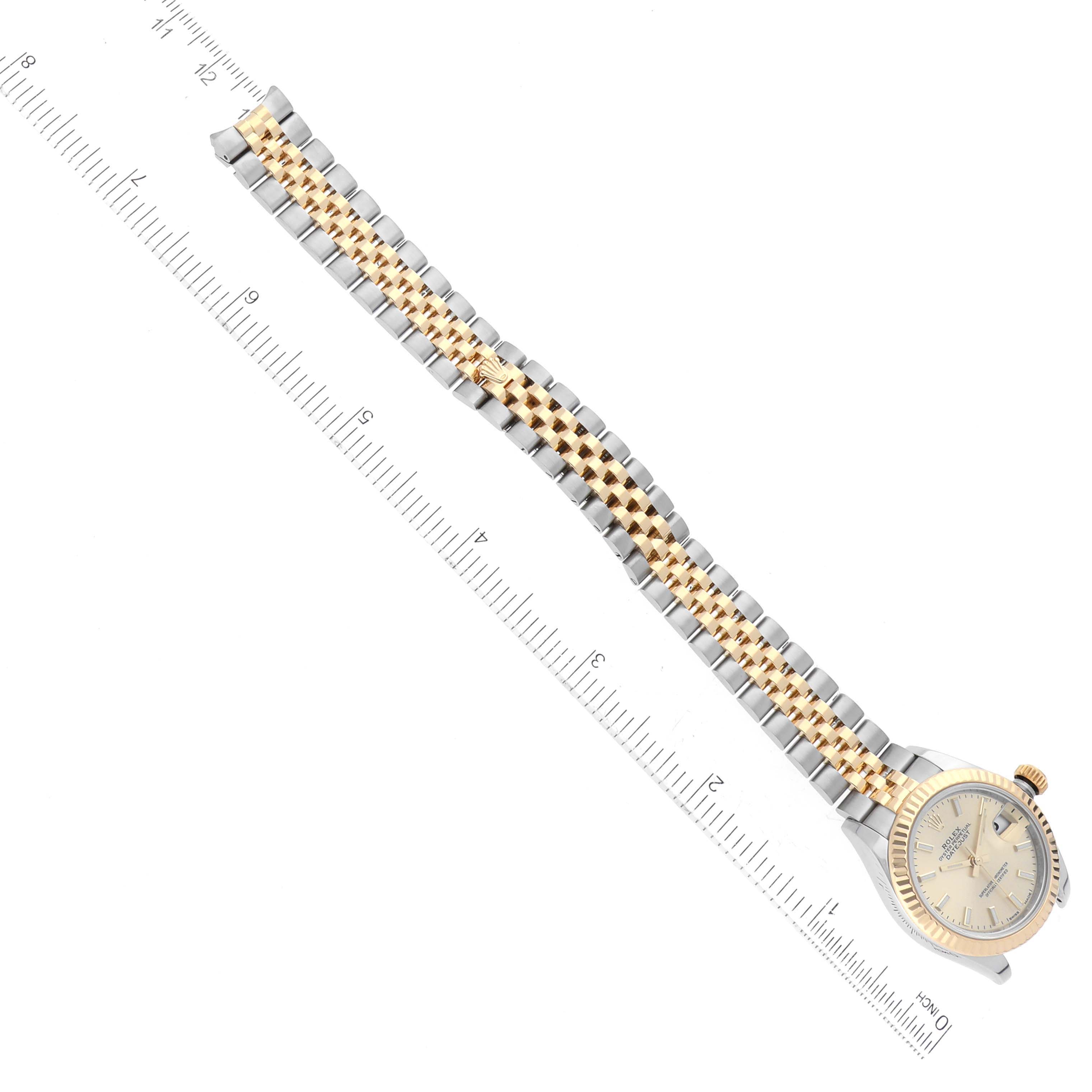 The Rolex Datejust 279173 Women's Steel and Gold (two tone) Champagne Dial 279173 Women's Steel and Gold (two tone) Champagne Dial watch is shown from above, displaying the dial and the entire bracelet with a ruler for scale.
