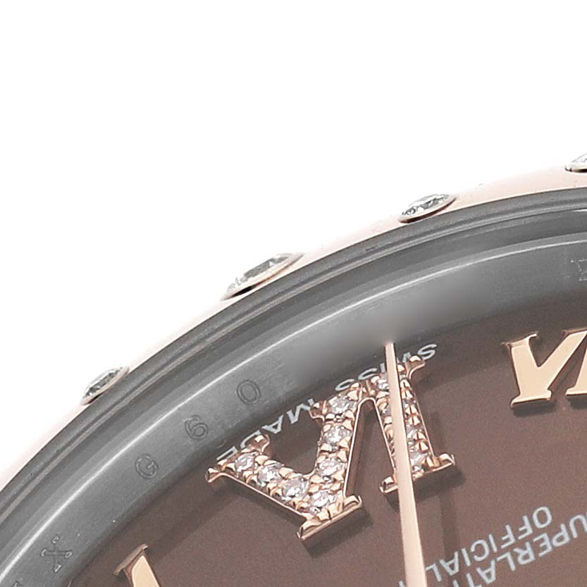 The close-up image of the Rolex Datejust 178341 Women's Steel and Gold (two tone) Brown Dial shows the bezel, part of the face, and detailed Roman numerals.