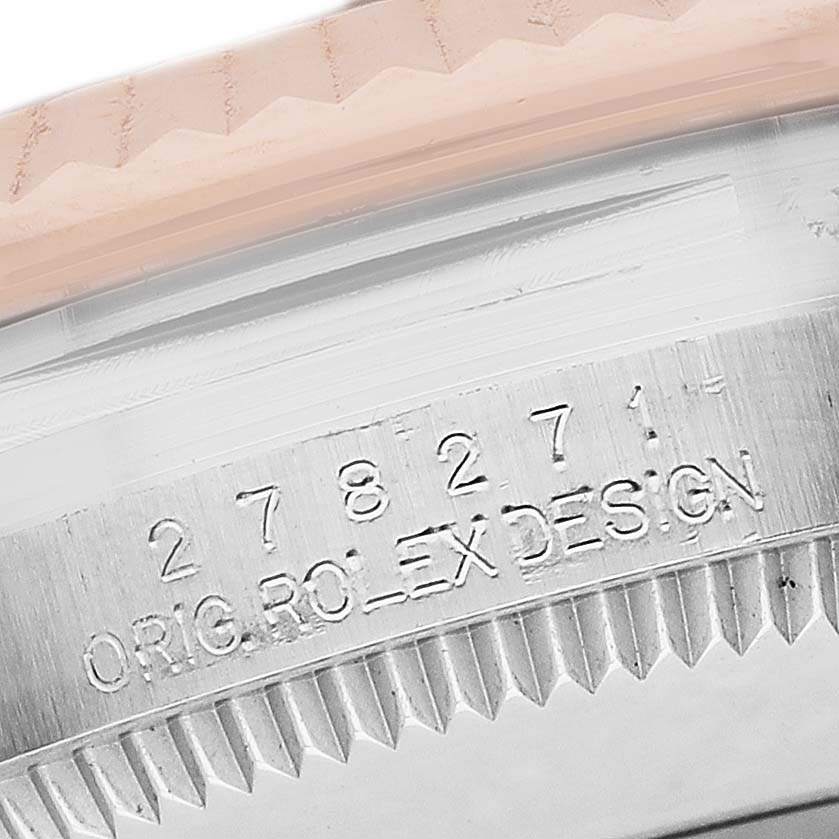The image shows a close-up of the side view of a Rolex Datejust 278271 Women's Stainless Steel Silver Dial model case with engraved text and fluted bezel.