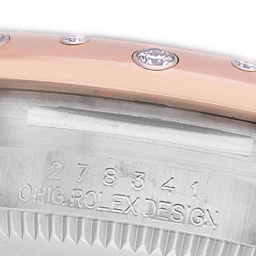 The image shows a close-up of the engraved case side and diamond-set bezel of a Rolex Datejust 278341 Women's Steel and Gold (two tone) Brown Dial watch.