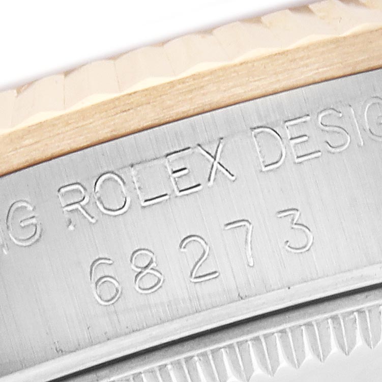 The image shows a close-up of the case side with engraved design details of the Mid-Size Rolex model.