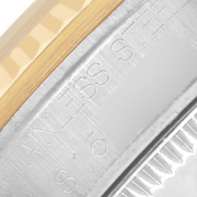 The image shows a close-up of the side of a Rolex Mid-Size 68273 Women's Steel and Gold (two tone) Champagne Dial 68273 Women's Steel and Gold (two tone) Champagne Dial model, highlighting the bezel and part of the engraved case.