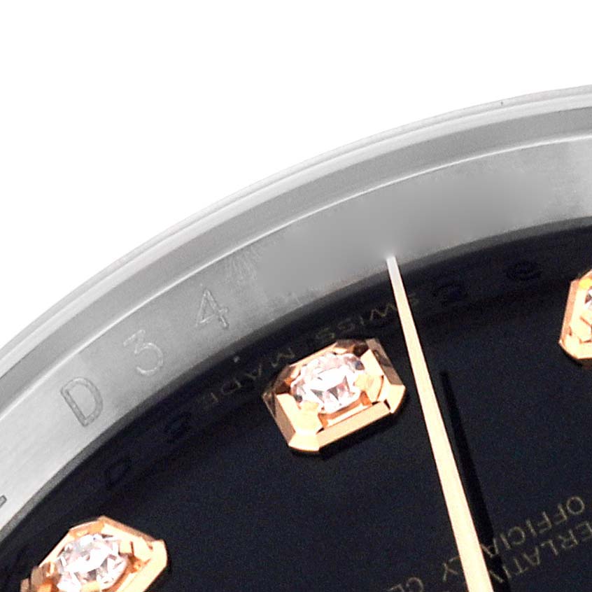 This close-up image of the Rolex Datejust 116231 Men's Steel and Gold (two tone) Black Dial 116231 Men's Steel and Gold (two tone) Black Dial watch shows part of the bezel, dial with diamond hour markers, and the tip of a hand.