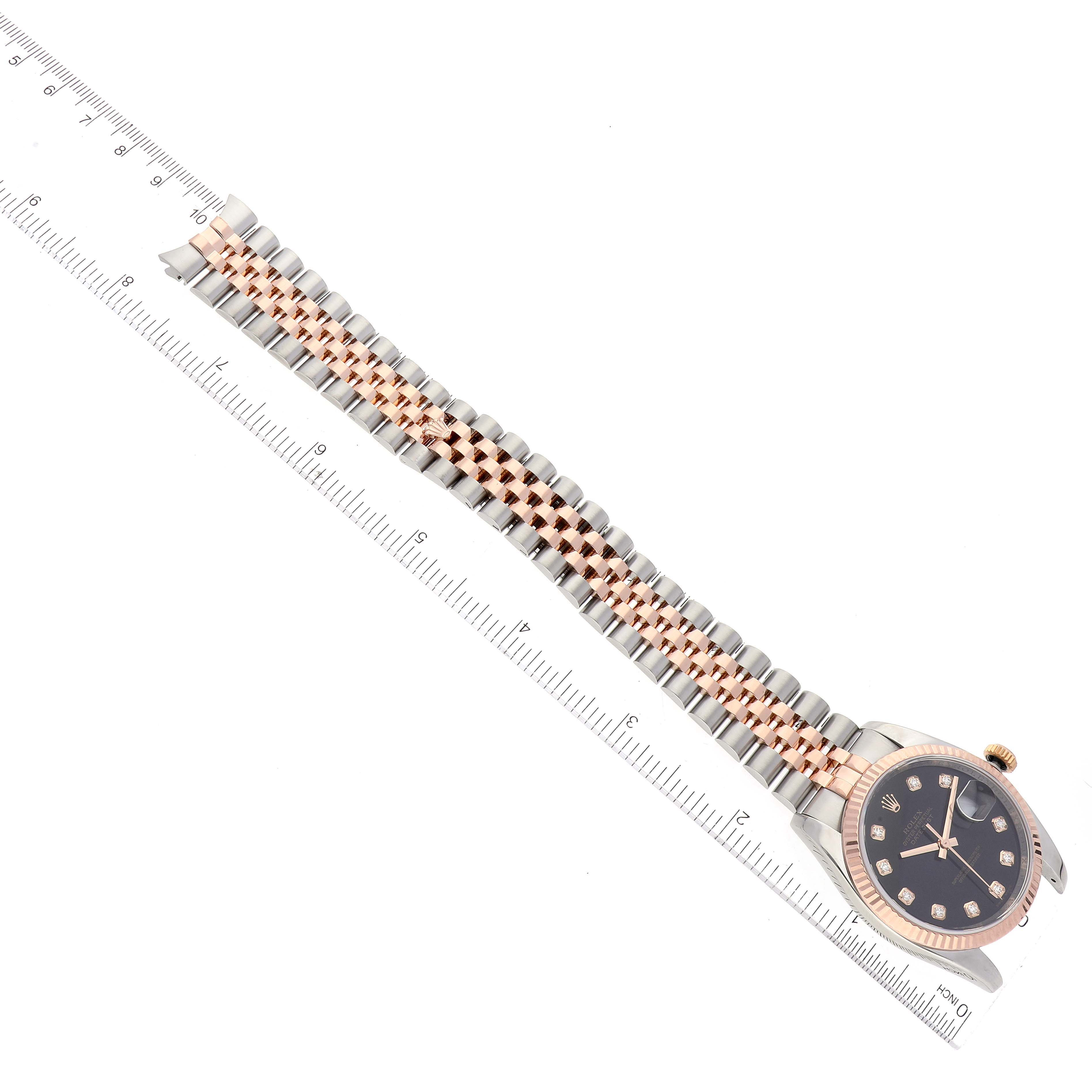 The image shows a Rolex Datejust 116231 Men's Steel and Gold (two tone) Black Dial 116231 Men's Steel and Gold (two tone) Black Dial watch with a two-tone bracelet and a black dial, photographed from an angled top view.