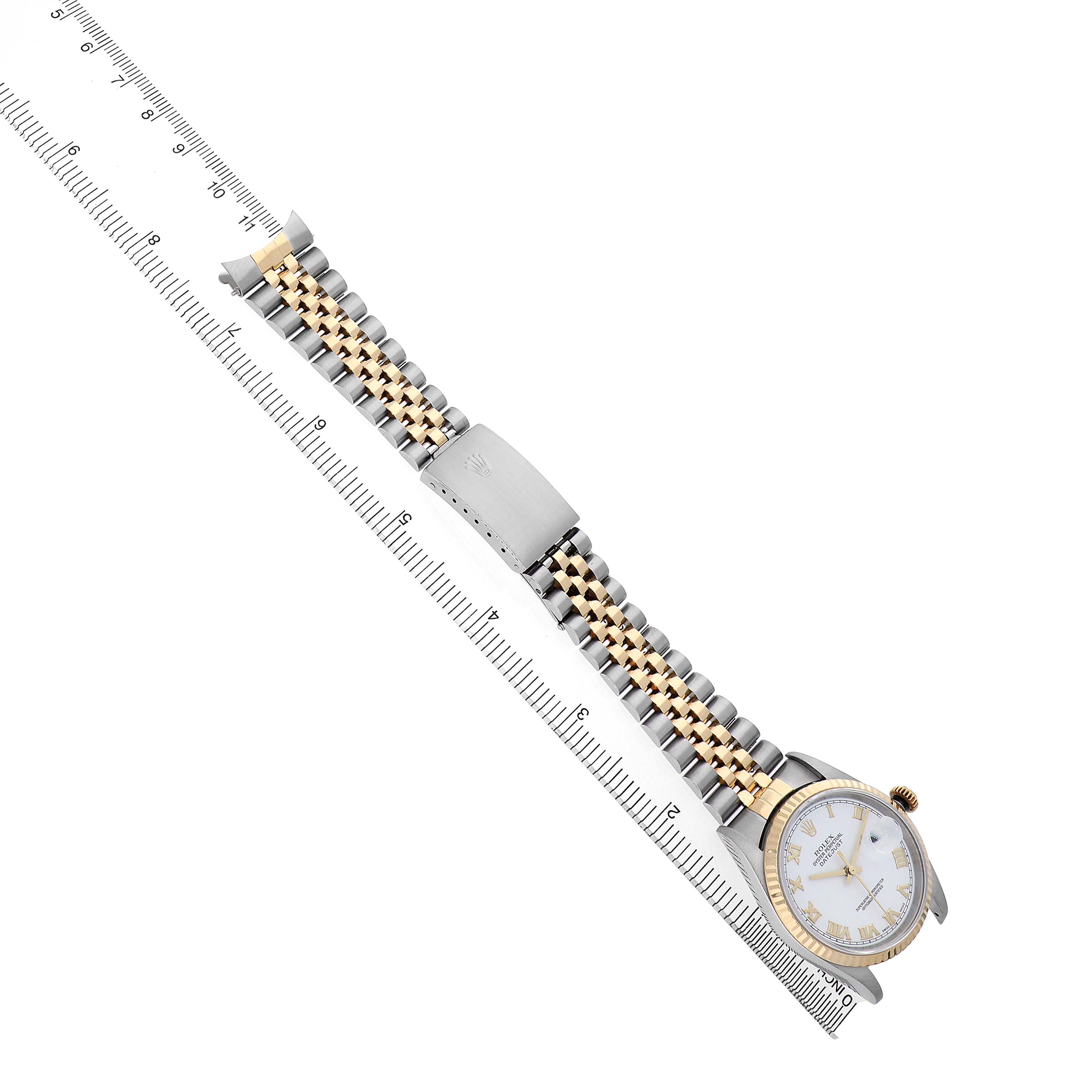The image shows a Rolex Datejust 16233 Men's Stainless Steel White Dial watch from a top view, highlighting the bezel, dial, hour markers, and two-tone bracelet alongside a ruler.