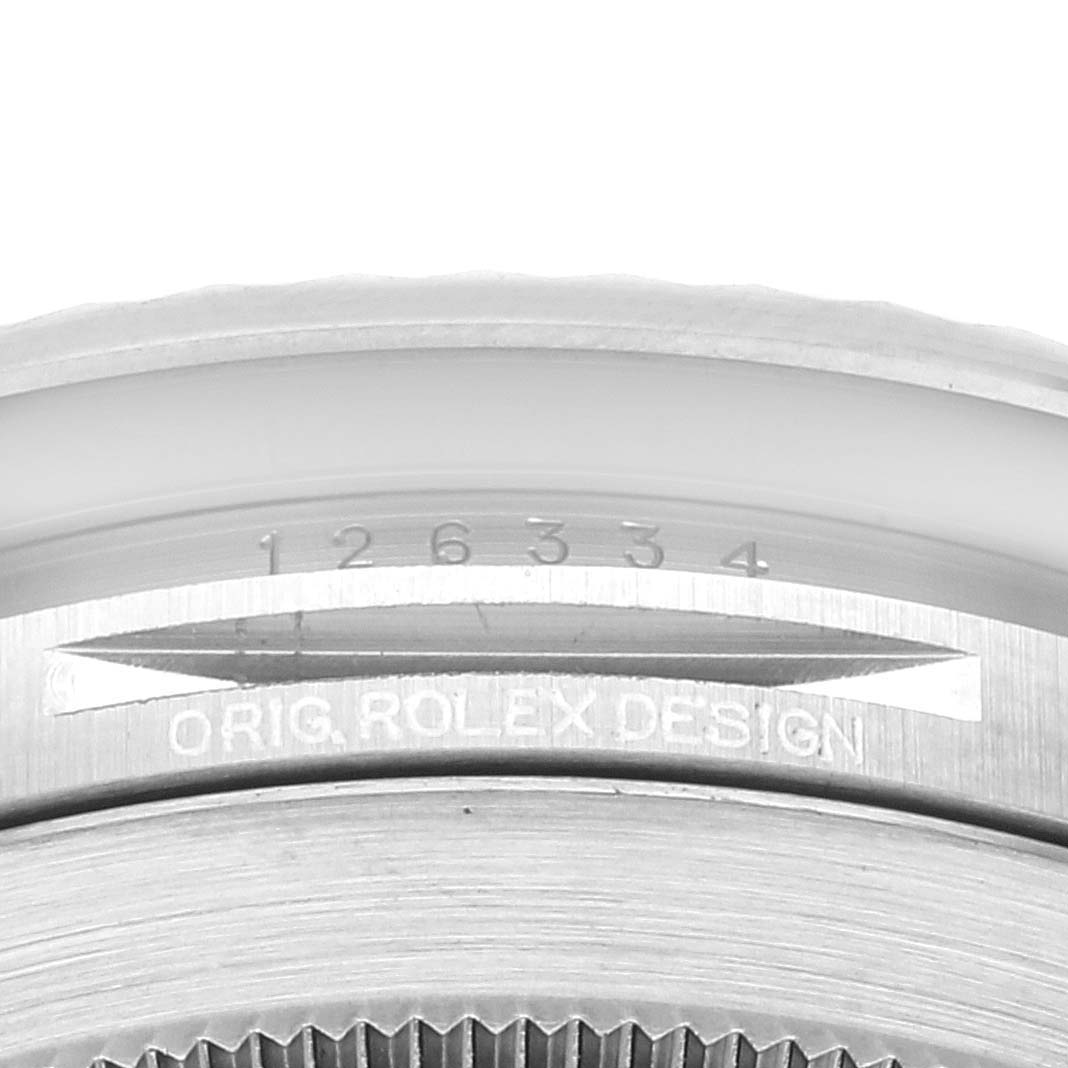 The image shows the serial number, bezel, and "ORIG. ROLEX DESIGN" engraving on a Rolex Datejust 41 126334 Men's Stainless Steel White Dial 126334 Men's Stainless Steel White Dial model.