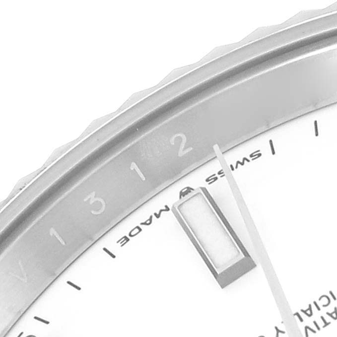 This close-up image of the Rolex Datejust 41 126334 Men's Stainless Steel White Dial 126334 Men's Stainless Steel White Dial watch shows part of the bezel, dial, and hands at an angled view.