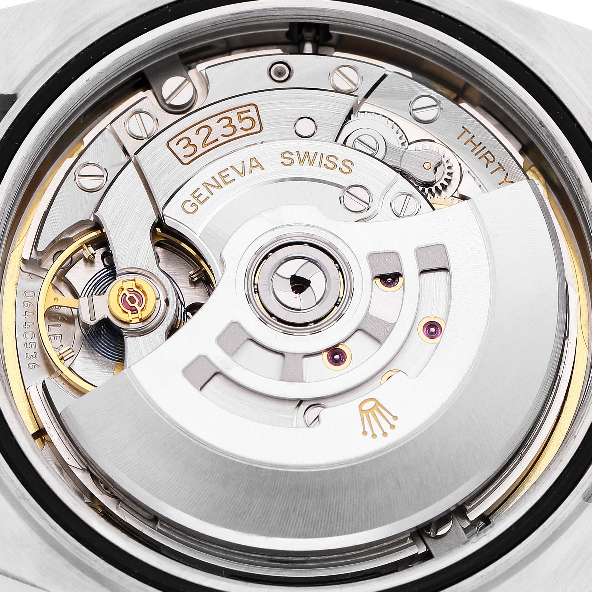 The image shows the intricate movement of a Rolex Datejust 41 126333 Men's Steel and Gold (two tone) Champagne Dial, highlighting the rotor and gear mechanisms from a top-down angle.