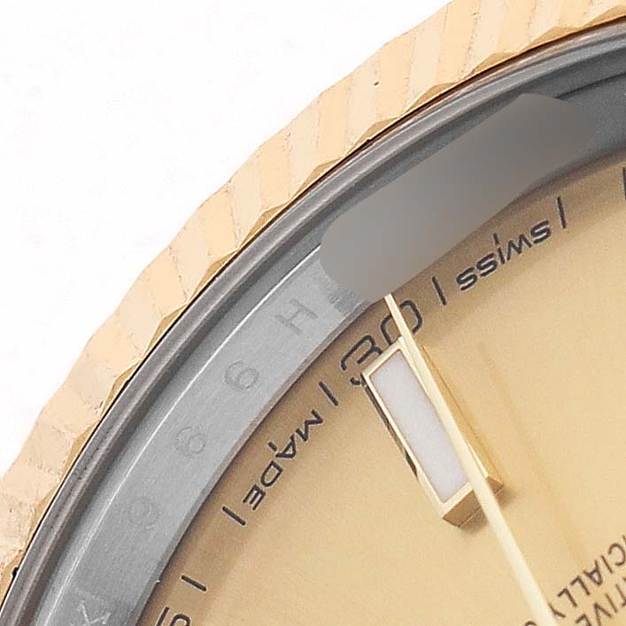 The image shows a close-up of the Rolex Datejust 41 126333 Men's Steel and Gold (two tone) Champagne Dial's bezel, partial dial, and hands from an angled top view.