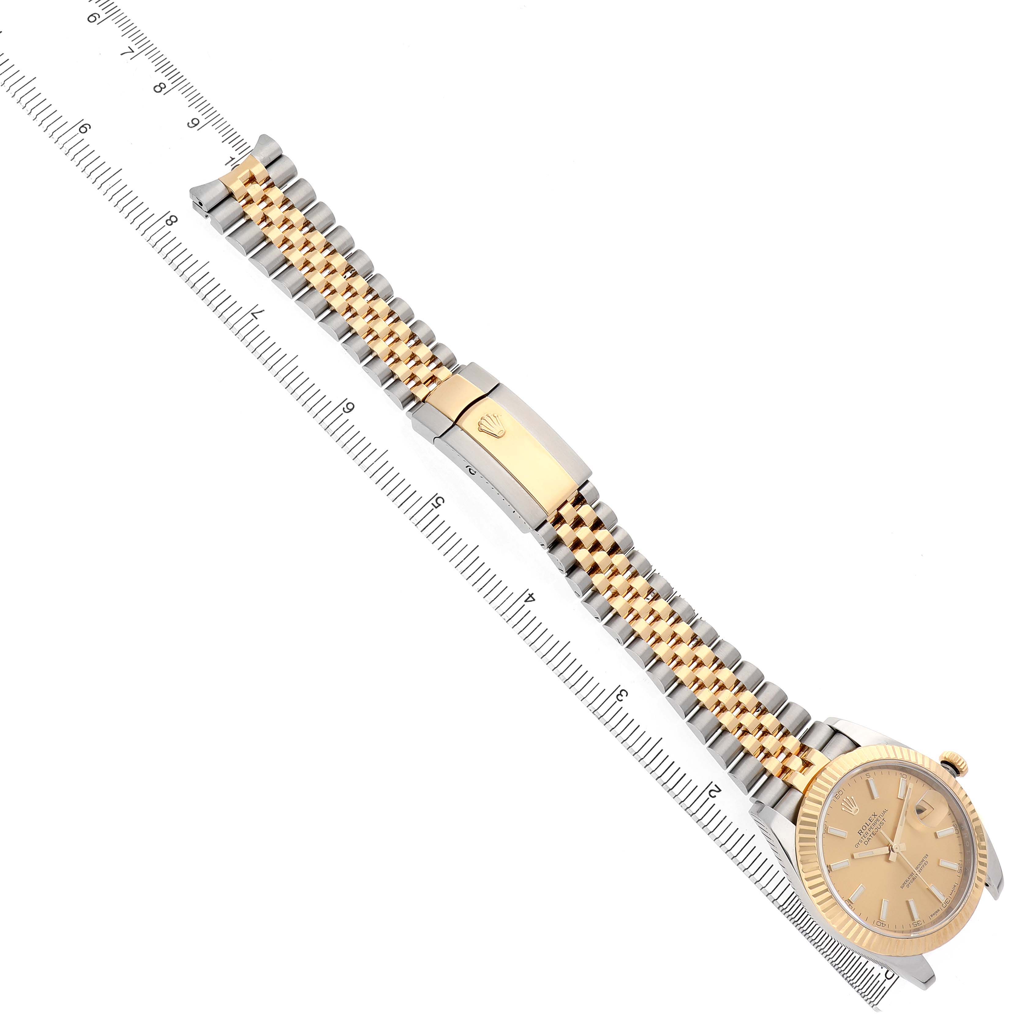 The Rolex Datejust 41 126333 Men's Steel and Gold (two tone) Champagne Dial watch is shown from a top angle, displaying the dial, bezel, and Jubilee bracelet alongside a ruler for scale.