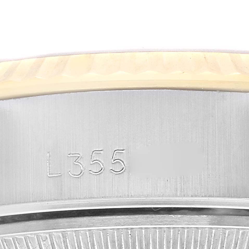 The image shows a close-up of the Rolex Datejust 69173 Women's Steel and Gold (two tone) Champagne Dial 69173 Women's Steel and Gold (two tone) Champagne Dial watch's case edge featuring part of the serial number engraving.