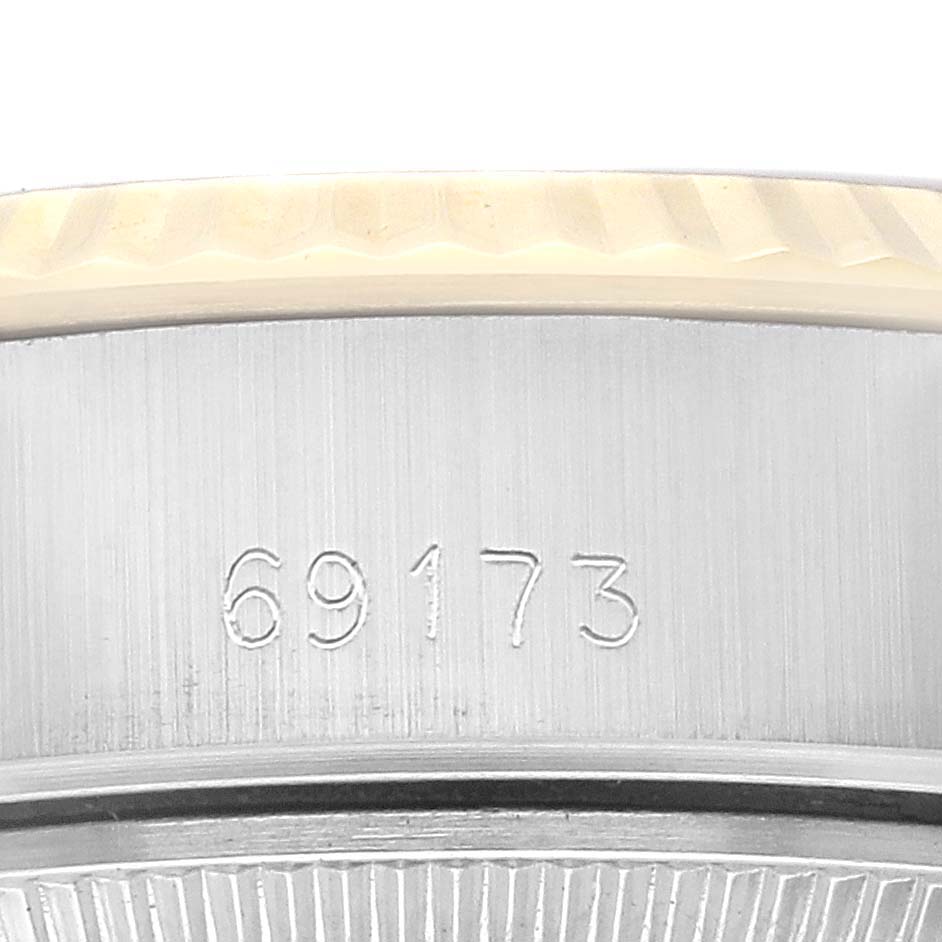 This image shows a close-up of the side of a Rolex Datejust 69173 Women's Steel and Gold (two tone) Champagne Dial 69173 Women's Steel and Gold (two tone) Champagne Dial watch with model number 69173 engraved.