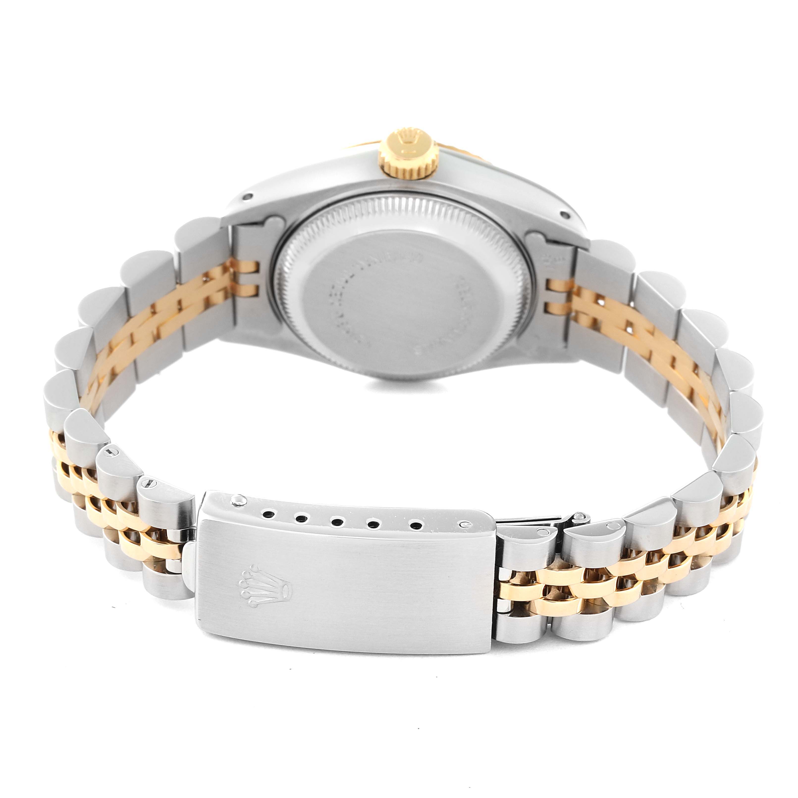 The image shows the back of a Datejust by Rolex, highlighting the case back, crown, and two-tone bracelet with the clasp.