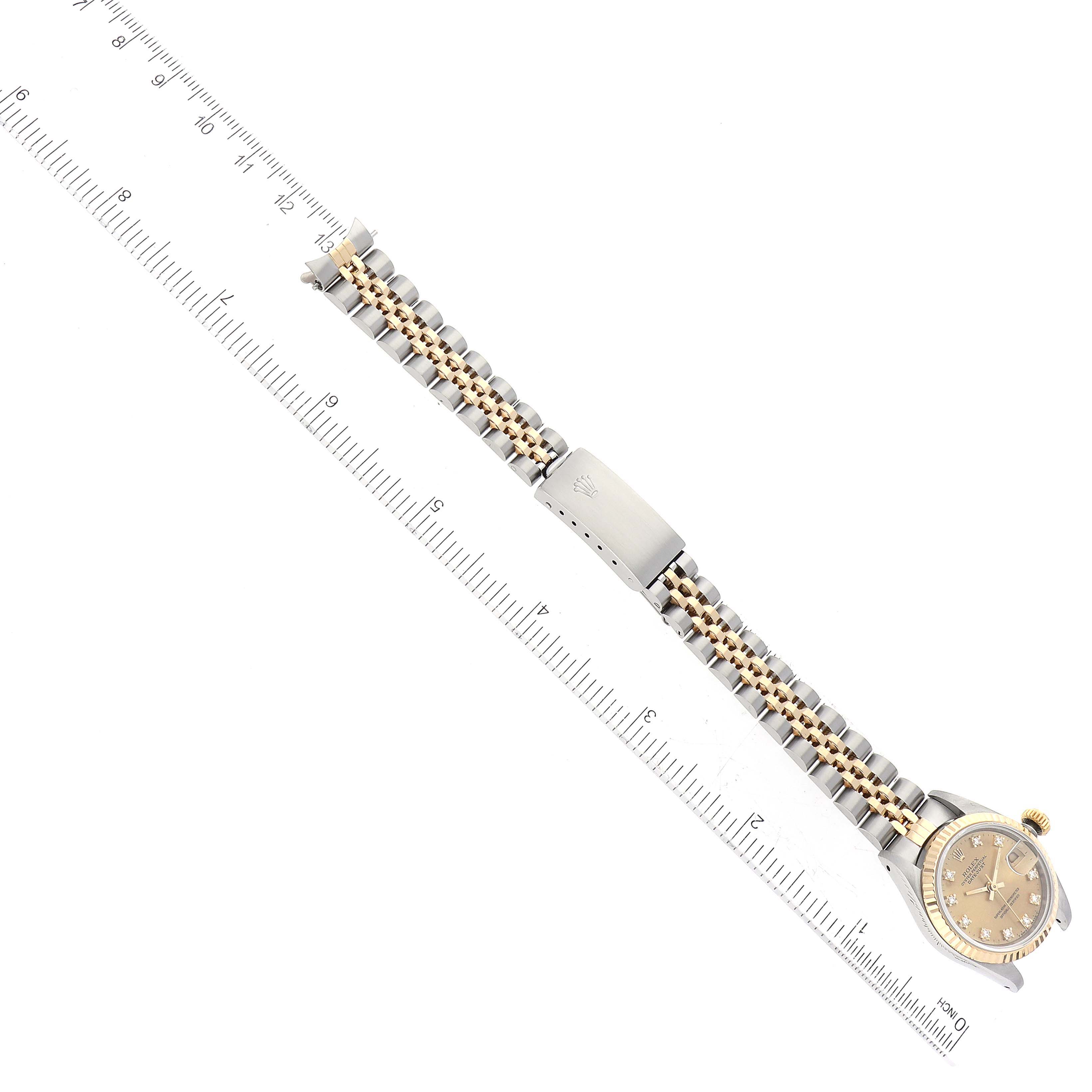 The image shows a Rolex Datejust 69173 Women's Steel and Gold (two tone) Champagne Dial 69173 Women's Steel and Gold (two tone) Champagne Dial watch laid flat with a ruler for measurement, displaying the watch face and the entire two-tone bracelet.