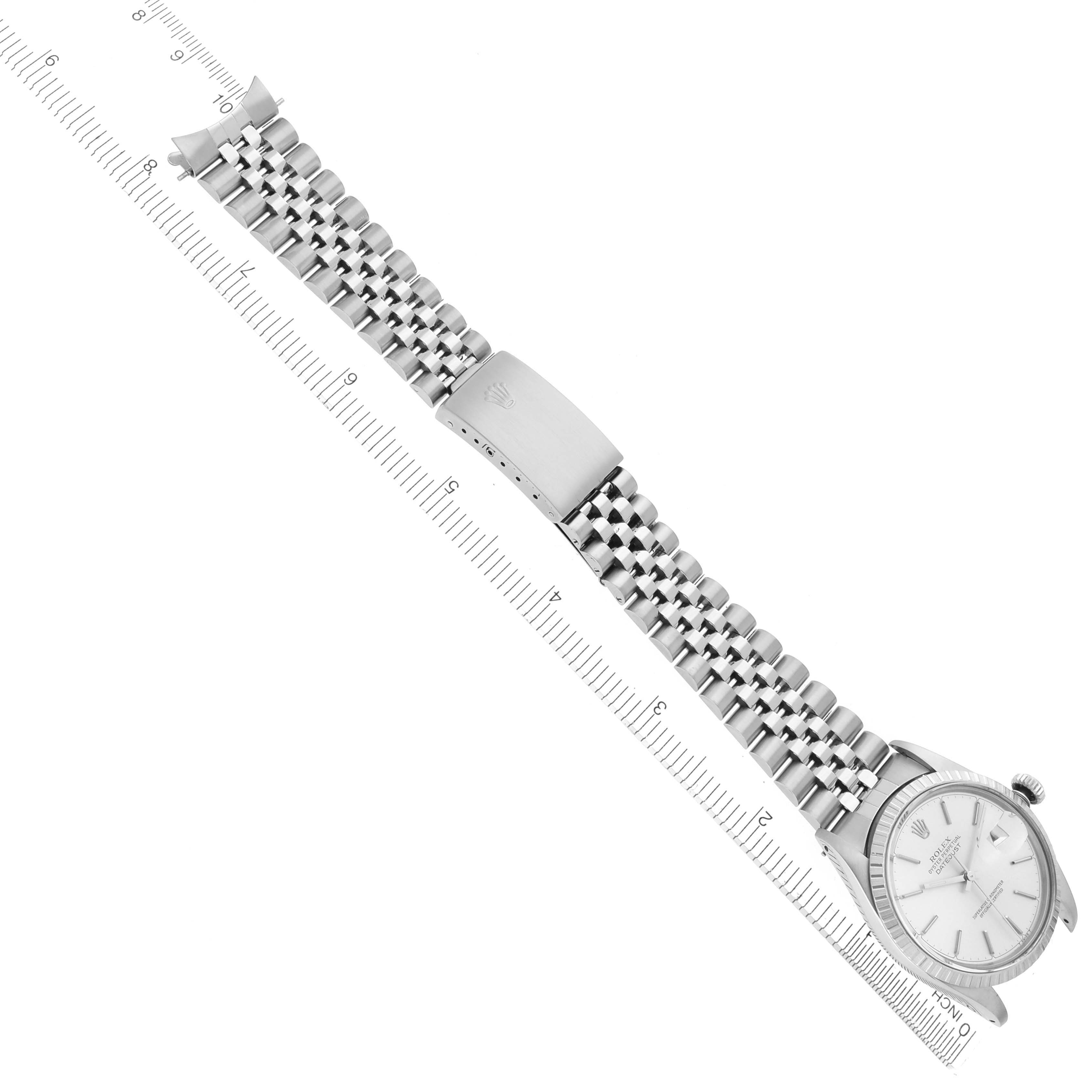 The Rolex Datejust 16030 Men's Stainless Steel Silver Dial 16030 Men's Stainless Steel Silver Dial watch is shown at an angle, displaying the face, bracelet, clasp, and part of a ruler alongside it.