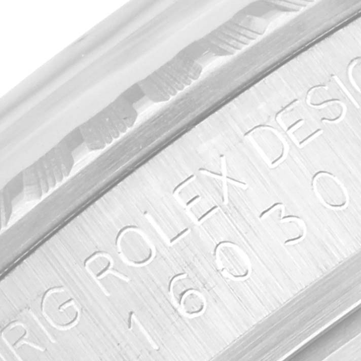 The image shows a close-up of the engraved side of a Vintage Collection Rolex, focusing on the model number and design details.