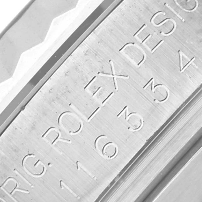 The image shows the engraved inner bezel of a Rolex Datejust 41 116334 Men's Stainless Steel Grey Dial 116334 Men's Stainless Steel Grey Dial watch at a close angle.