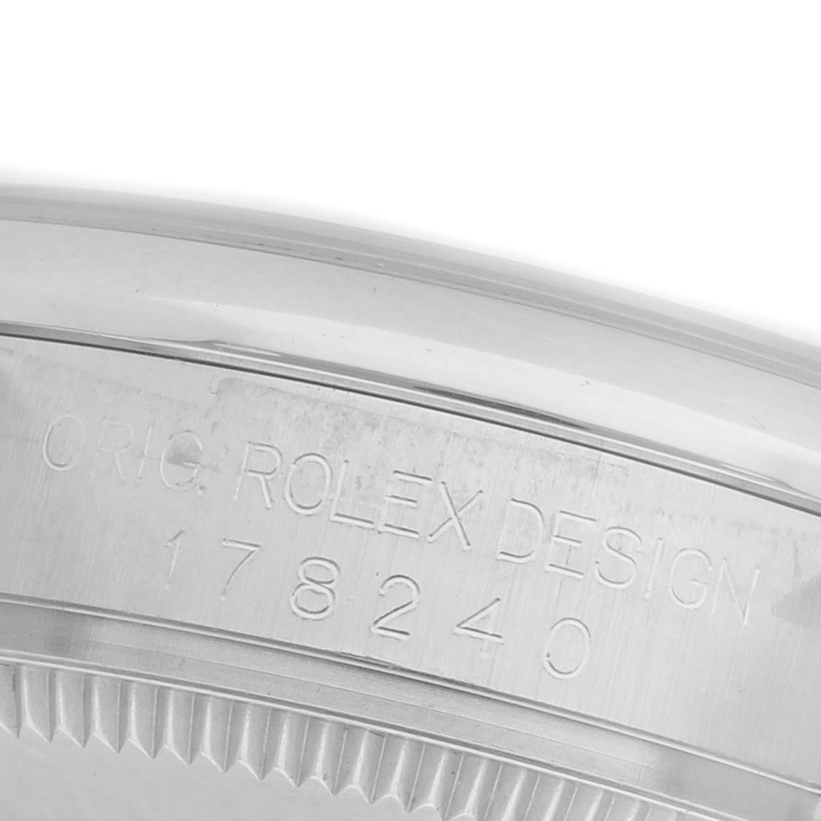 The image shows the side of a Rolex Mid-Size 178240 Women's Stainless Steel White Dial 178240 Women's Stainless Steel White Dial model with engraved details, featuring part of the watch case.