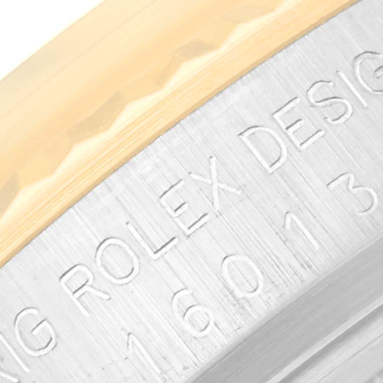 The image shows a close-up of the engraved text and the bezel edge of the Vintage Collection Rolex model.