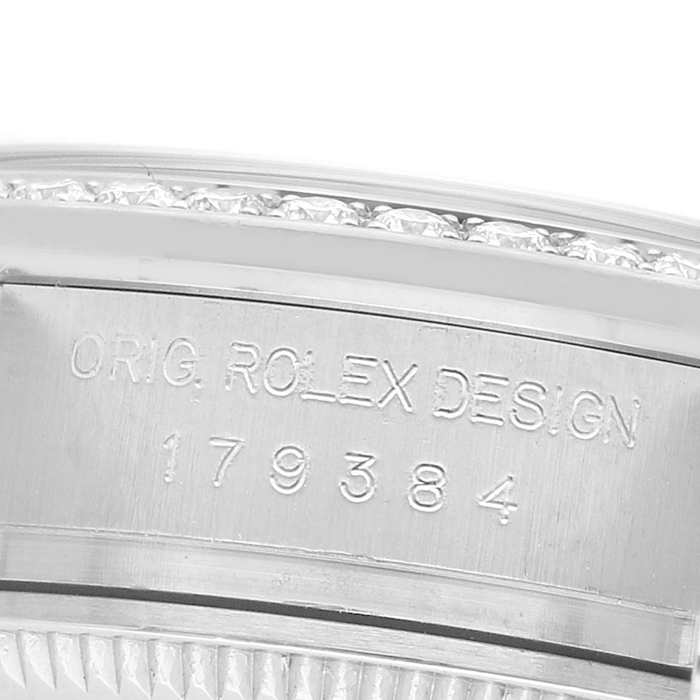 The image shows a close-up of the Rolex Datejust 179384 Women's Stainless Steel Pink Dial's side, featuring the engraved model number and decorative bezel.