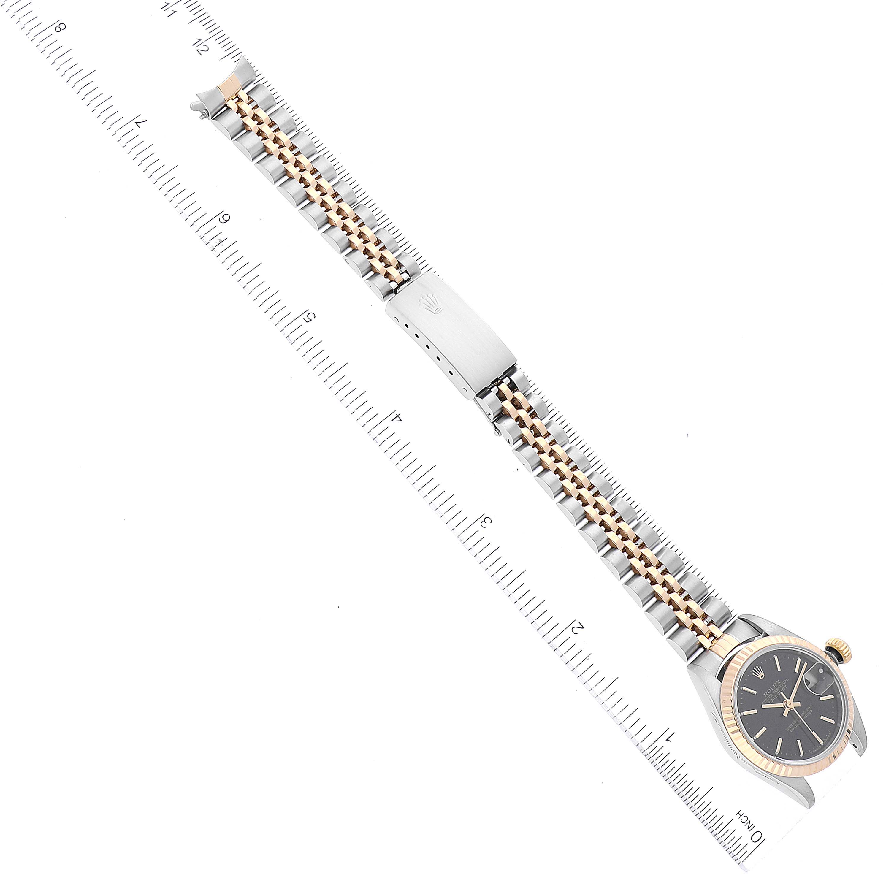 The image shows a Rolex Datejust 79173 Women's Steel and Gold (two tone) Black Dial 79173 Women's Steel and Gold (two tone) Black Dial watch from an overhead angle, including the full bracelet, clasp, and dial.