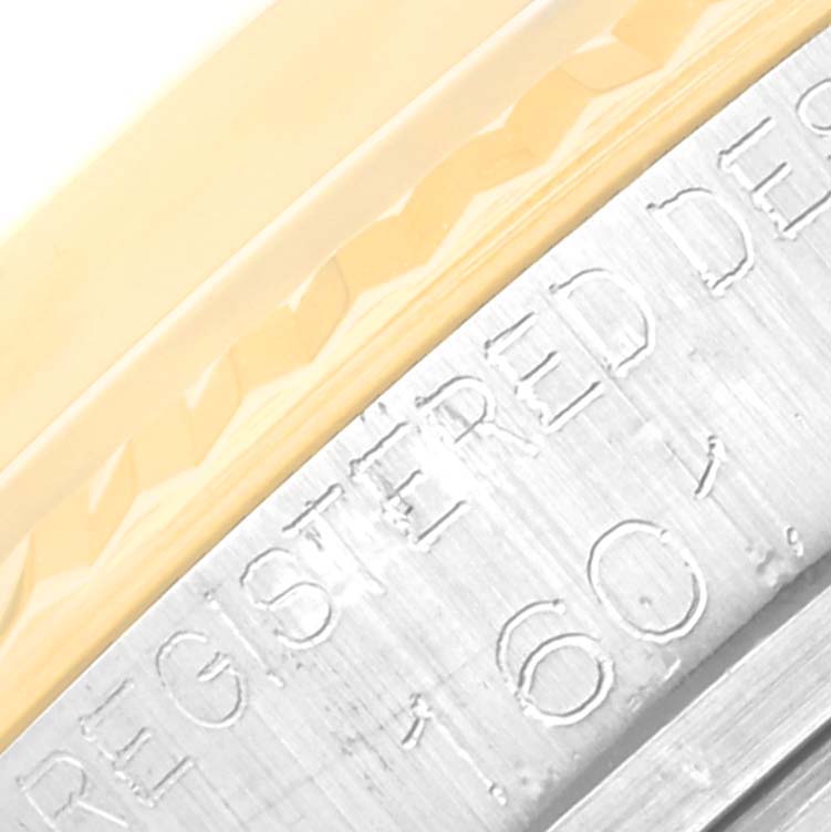 This close-up of the Rolex Vintage Collection 1601/3 Men's Steel and Gold (two tone) Black Dial 1601/3 Men's Steel and Gold (two tone) Black Dial watch shows the engraved text on the edge of the bezel.