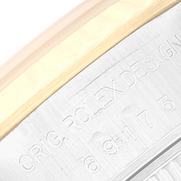 This close-up image shows part of the bezel and engraved markings on the case of the Rolex Datejust 69173 Women's Steel and Gold (two tone) Blue Dial 69173 Women's Steel and Gold (two tone) Blue Dial watch.