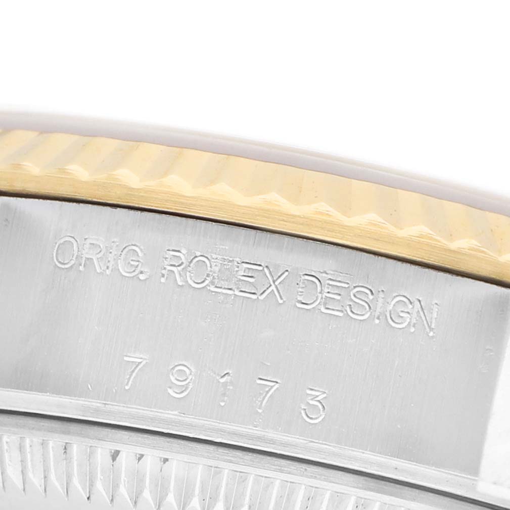 The image shows a close-up of the side of a Rolex Datejust 79173 Women's Stainless Steel Champagne Dial watch, highlighting the "Orig. Rolex Design" engraving and model number.