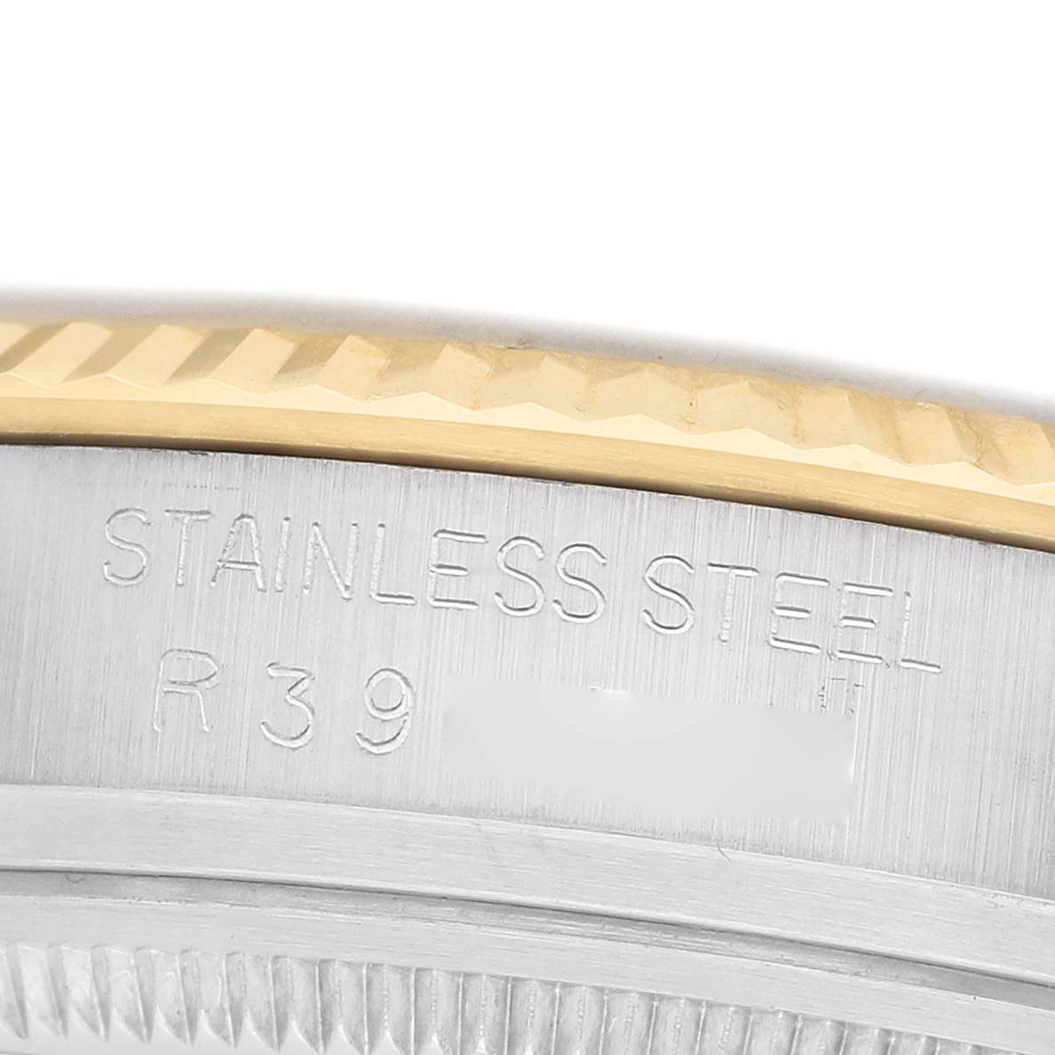 The image shows a close-up of the side of a Rolex Datejust 16013 Men's Steel and Gold (two tone) Champagne Dial watch, highlighting the stainless steel and gold fluted bezel.
