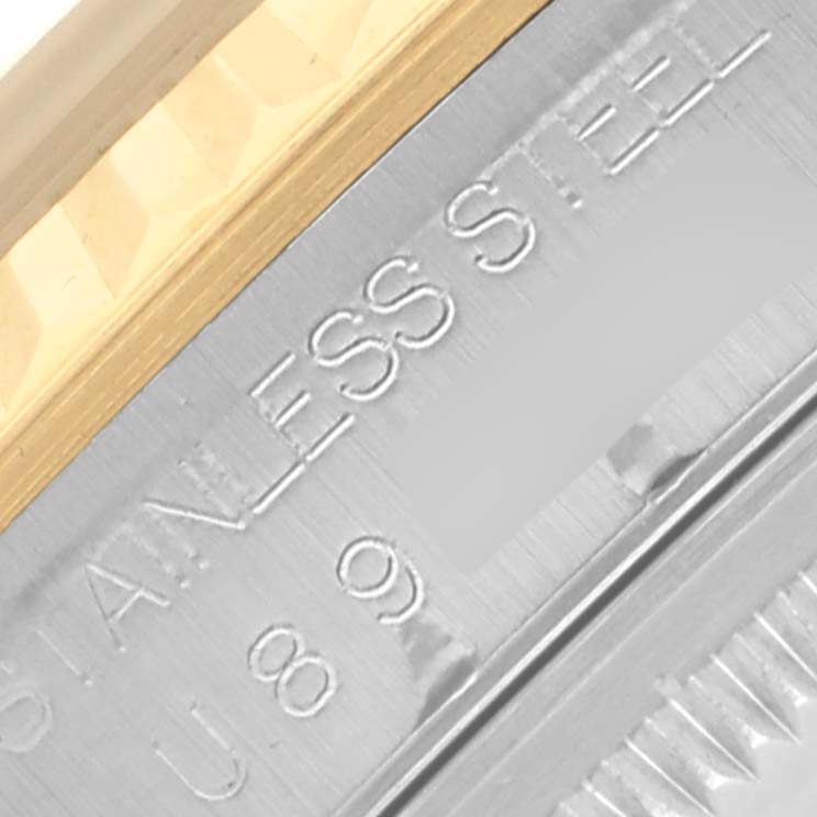 The image shows a close-up of the side of a Rolex Datejust 16233 Men's Steel and Gold (two tone) Silver Dial 16233 Men's Steel and Gold (two tone) Silver Dial, highlighting the stainless steel and engravings.
