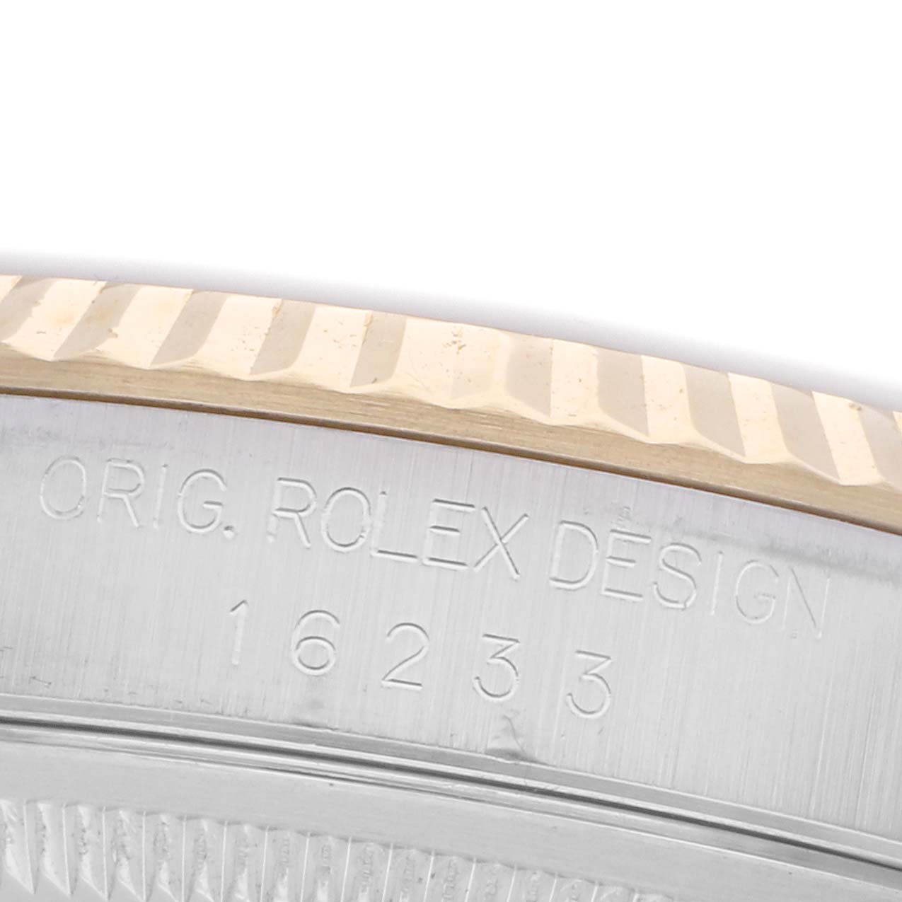 The image shows the side of a Rolex Datejust 16233 Men's Steel and Gold (two tone) Blue Dial 16233 Men's Steel and Gold (two tone) Blue Dial watch, highlighting the engraved model number and fluted bezel.