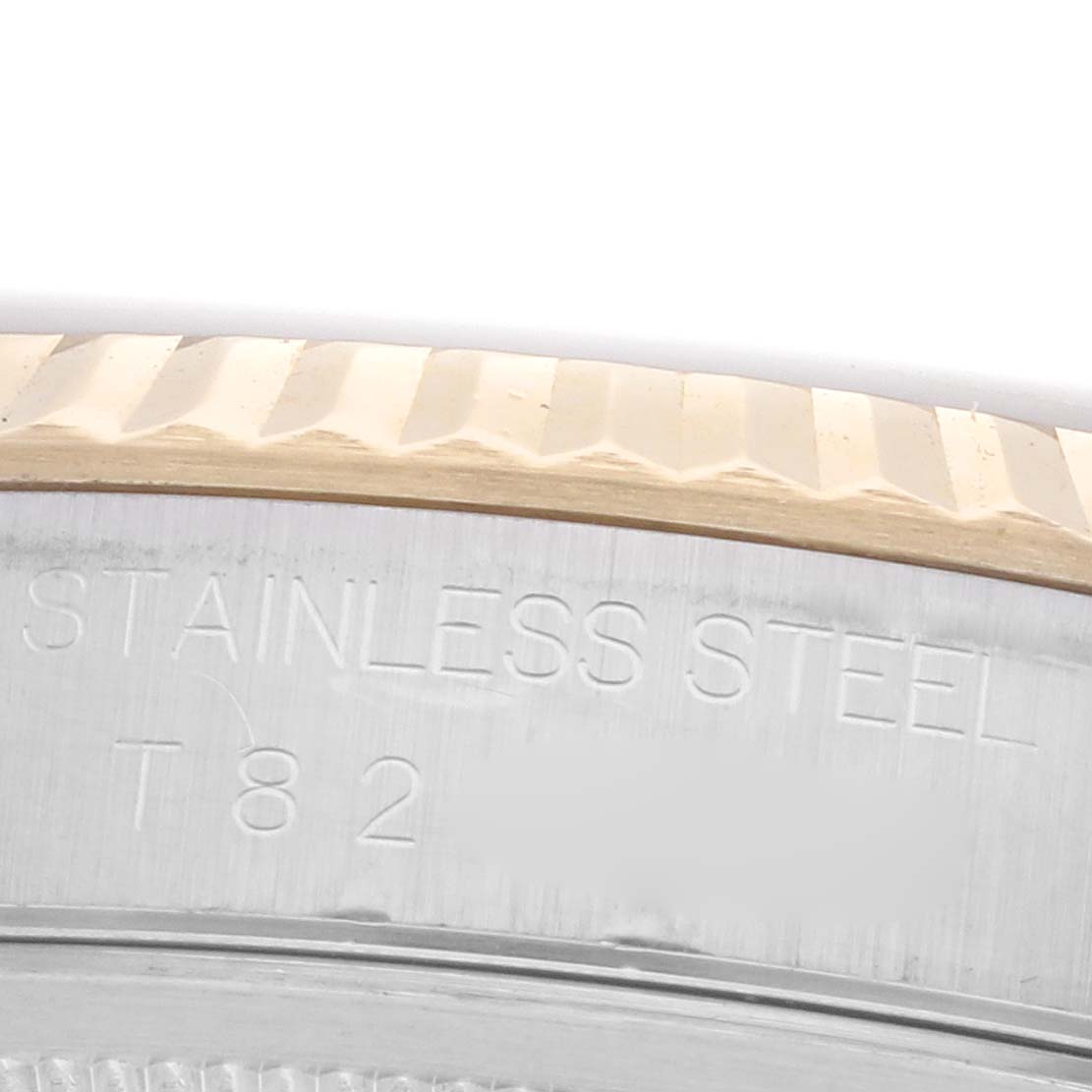 The image shows a close-up of the fluted bezel and stainless steel side of a Rolex Datejust 16233 Men's Steel and Gold (two tone) Blue Dial 16233 Men's Steel and Gold (two tone) Blue Dial watch.