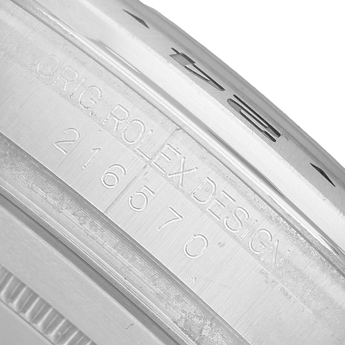 The image shows a close-up of the Rolex Explorer 216570 Men's Stainless Steel Black Dial model's inner bezel with engraved design details and model number.