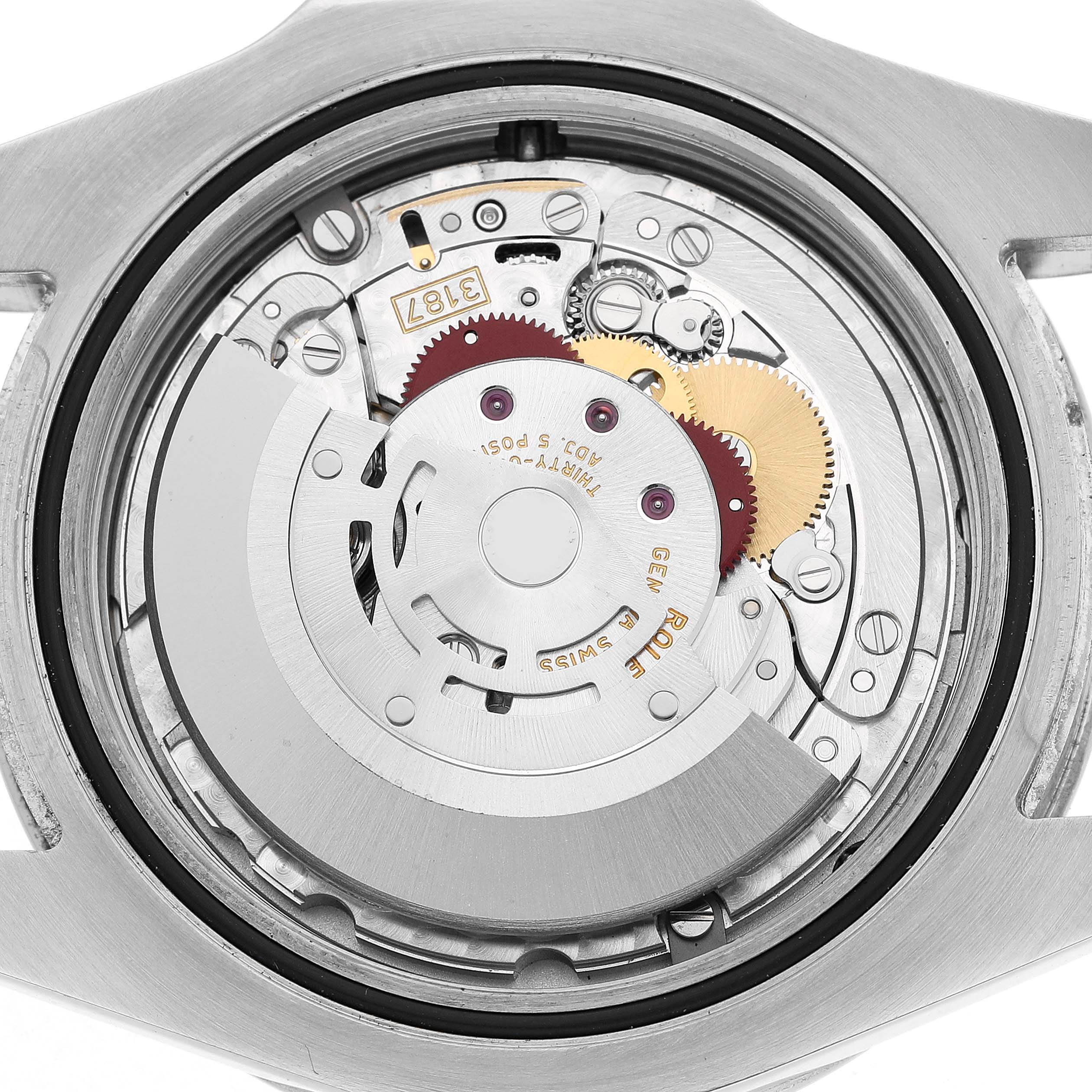 The image shows the back view of a Rolex Explorer 216570 Men's Stainless Steel Black Dial watch, highlighting its intricate internal movement and gears.