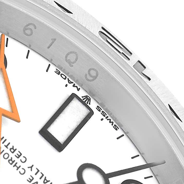 The image shows a close-up of a Rolex Explorer 226570 Men's Stainless Steel White Dial watch dial and part of the bezel, highlighting the hour markers and hands.