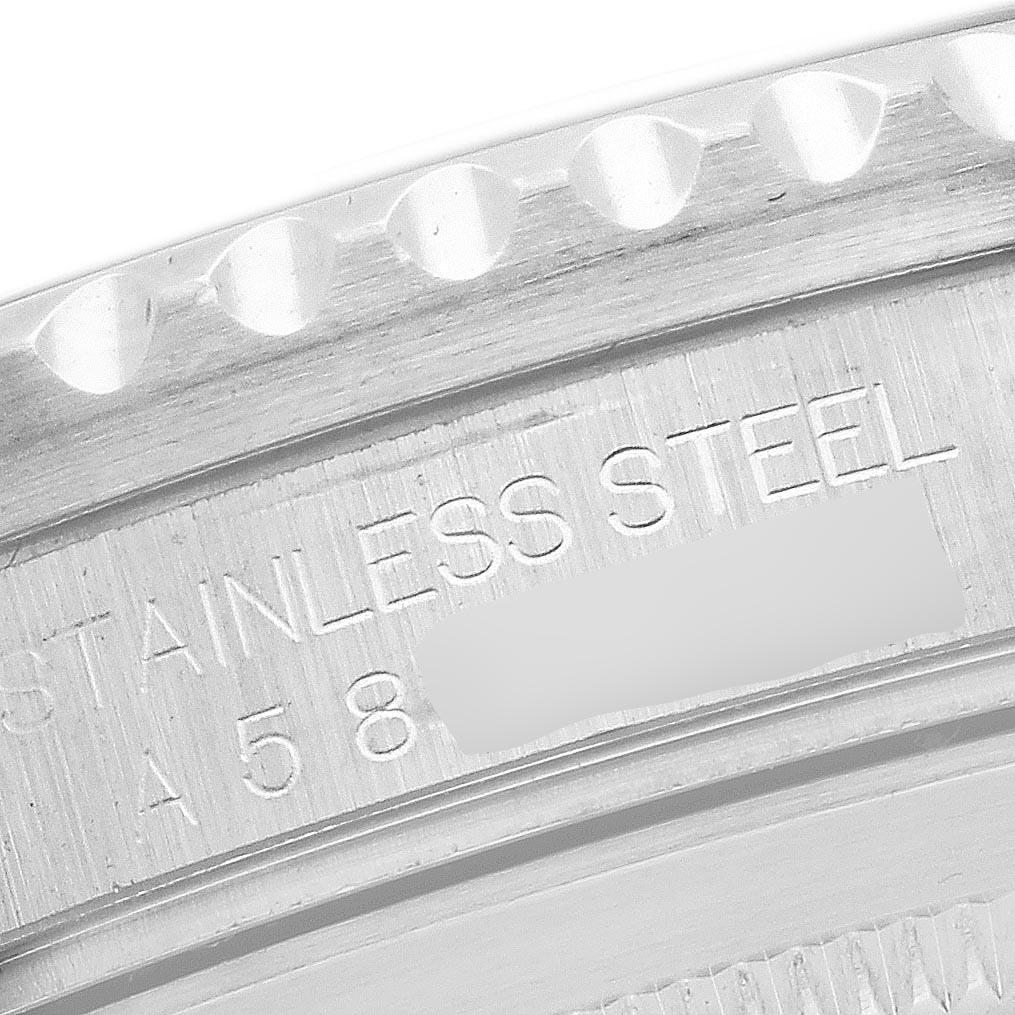 The image shows a close-up of the Rolex GMT-Master 16700 Men's Stainless Steel Black Dial 16700 Men's Stainless Steel Black Dial bezel edge and engraved markings on the stainless steel case.