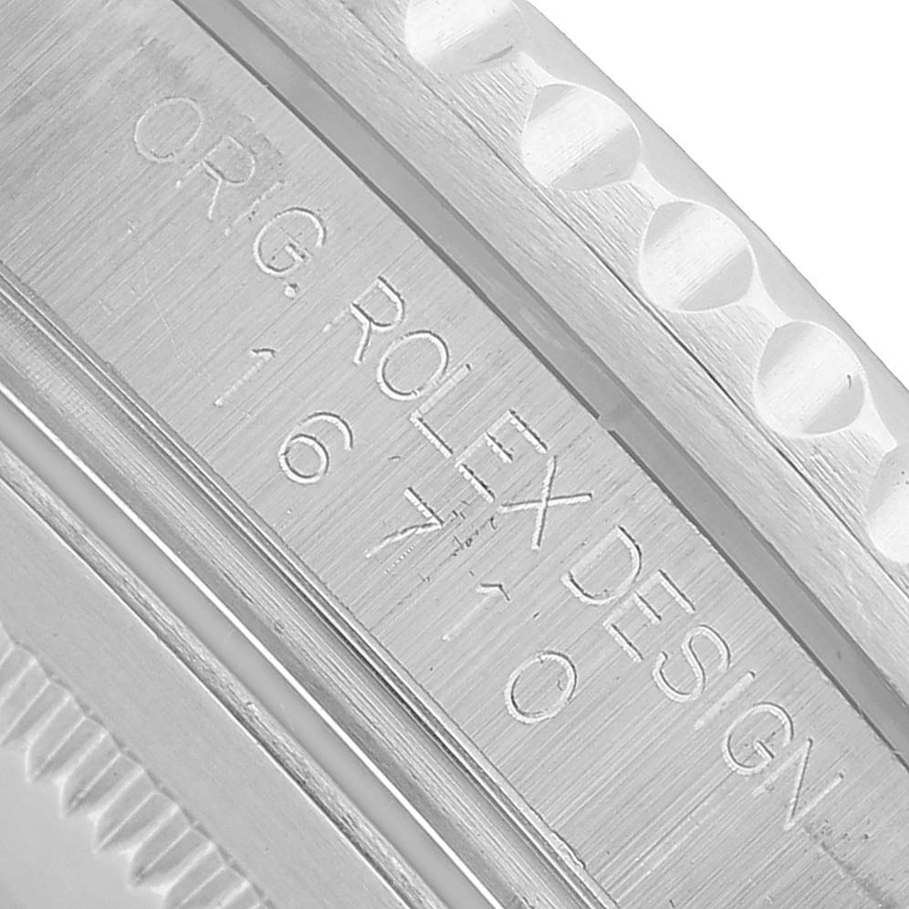 The image shows a close-up of the engraved inner bezel of a Rolex GMT-Master 16710 Men's Stainless Steel Black Dial watch.