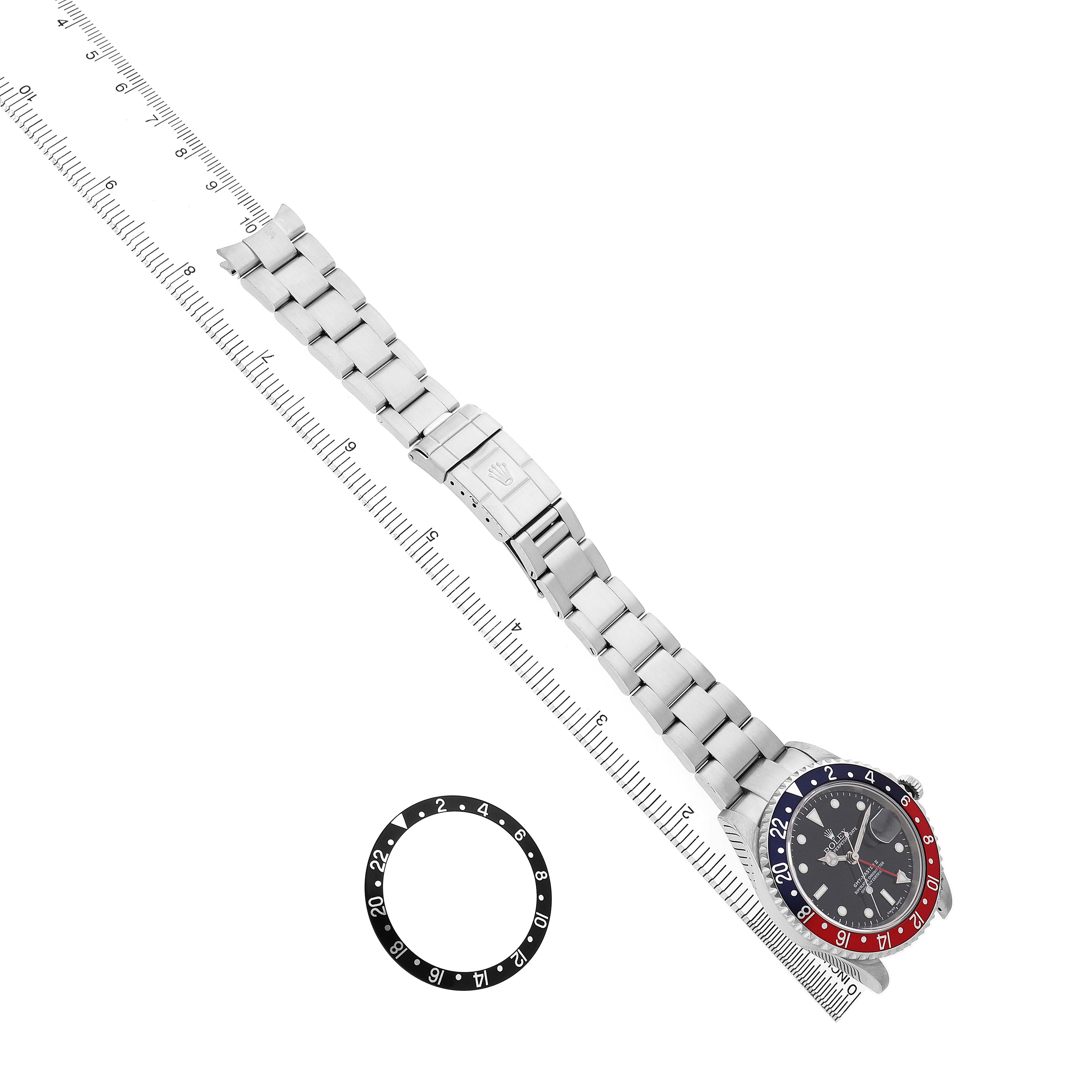 The Rolex GMT-Master 16710 Men's Stainless Steel Black Dial watch is displayed diagonally, showing the bracelet, clasp, bezel, and an additional bezel insert beside it.