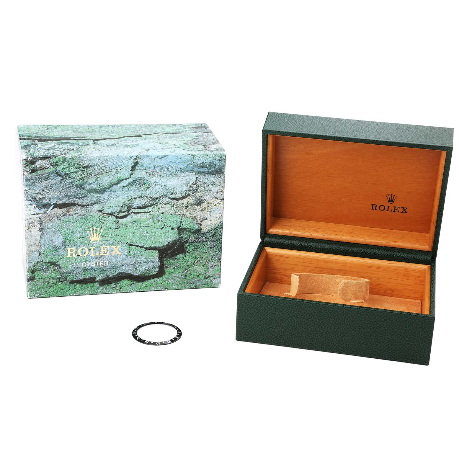 The image shows a Rolex GMT-Master 16710 Men's Stainless Steel Black Dial watch box open, revealing the interior, with an additional bezel accessory beside it.