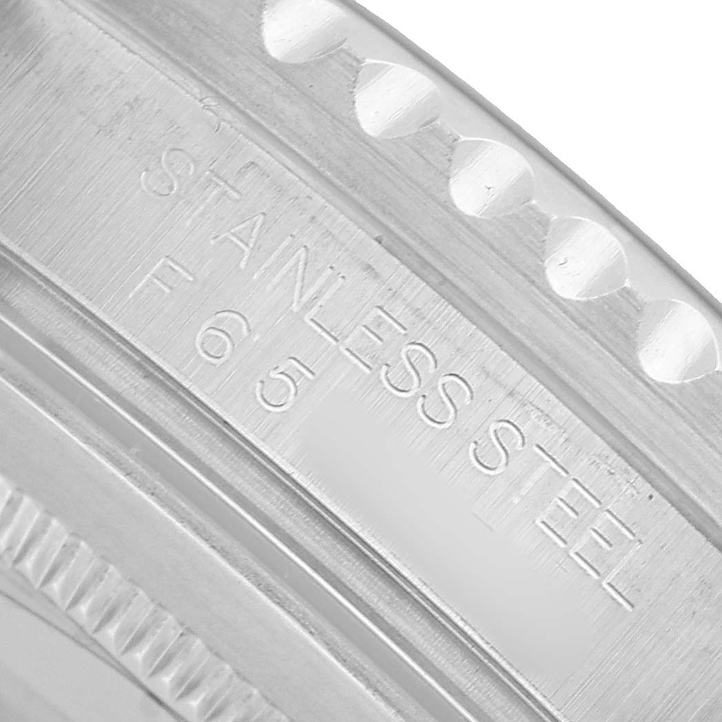 The image shows an engraved inner bezel of a Rolex GMT-Master 16710 Men's Stainless Steel Black Dial, highlighting the "STAINLESS STEEL" marking.