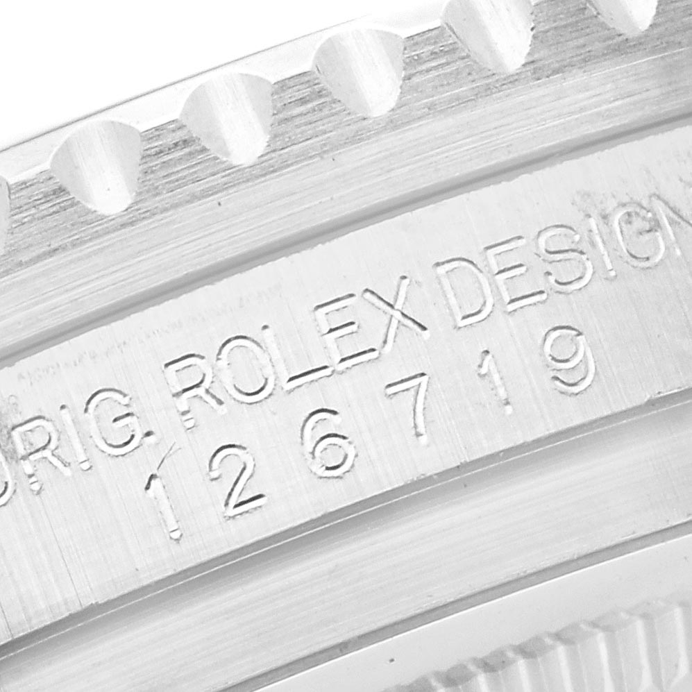 The image shows a close-up of the bezel and engraving on the casing of the Rolex GMT-Master 126719 Men's White Gold Blue Dial 126719 Men's White Gold Blue Dial.