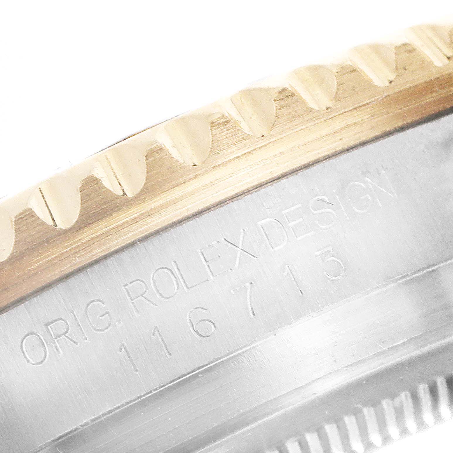 This close-up shows the side and bezel of a Rolex GMT-Master 116713 Men's Steel and Gold (two tone) Black Dial 116713 Men's Steel and Gold (two tone) Black Dial watch, including part of the model number and "ROLEX DESIGN" engraving.