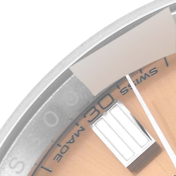 This Rolex Oyster Perpetual 116000 Men
s Stainless Steel Pink Dial 116000 Men
s Stainless Steel Pink Dial watch is shown at an angle highlighting the bezel, part of the dial, and minute markers.