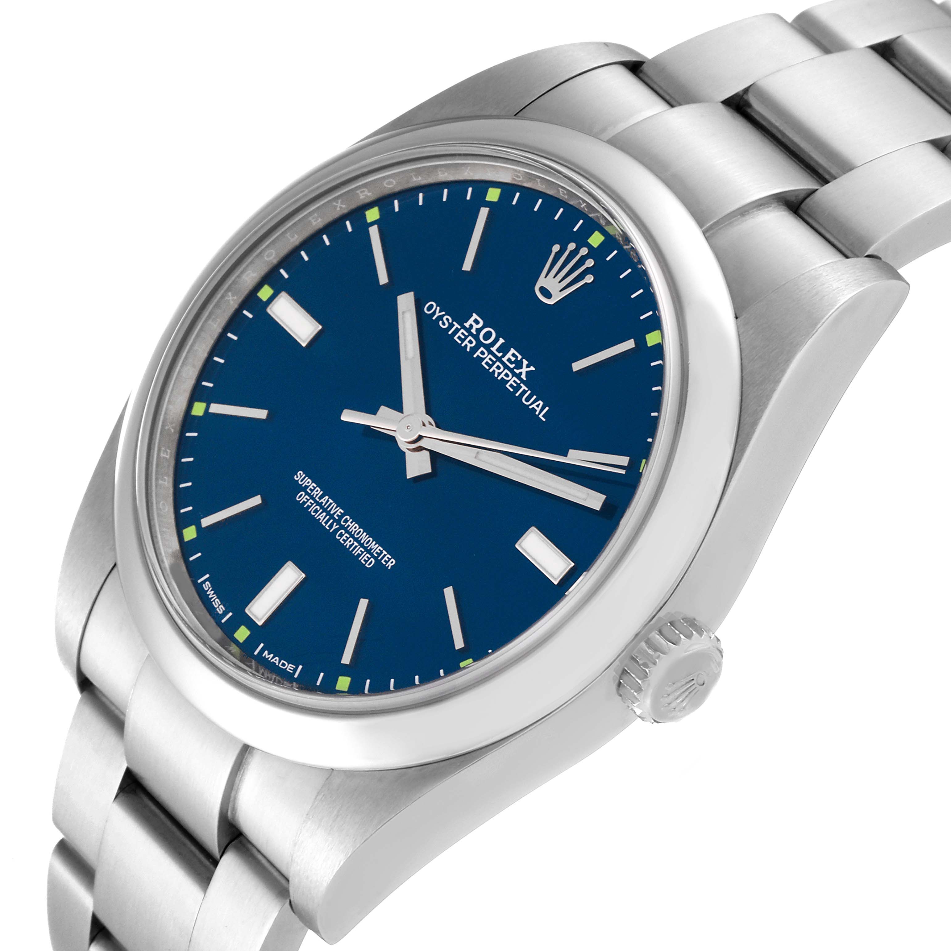The image shows a Rolex Oyster Perpetual 114300 Men's Stainless Steel Blue Dial 114300 Men's Stainless Steel Blue Dial watch at a slight angle, highlighting its blue dial, bezel, crown, and stainless steel bracelet.