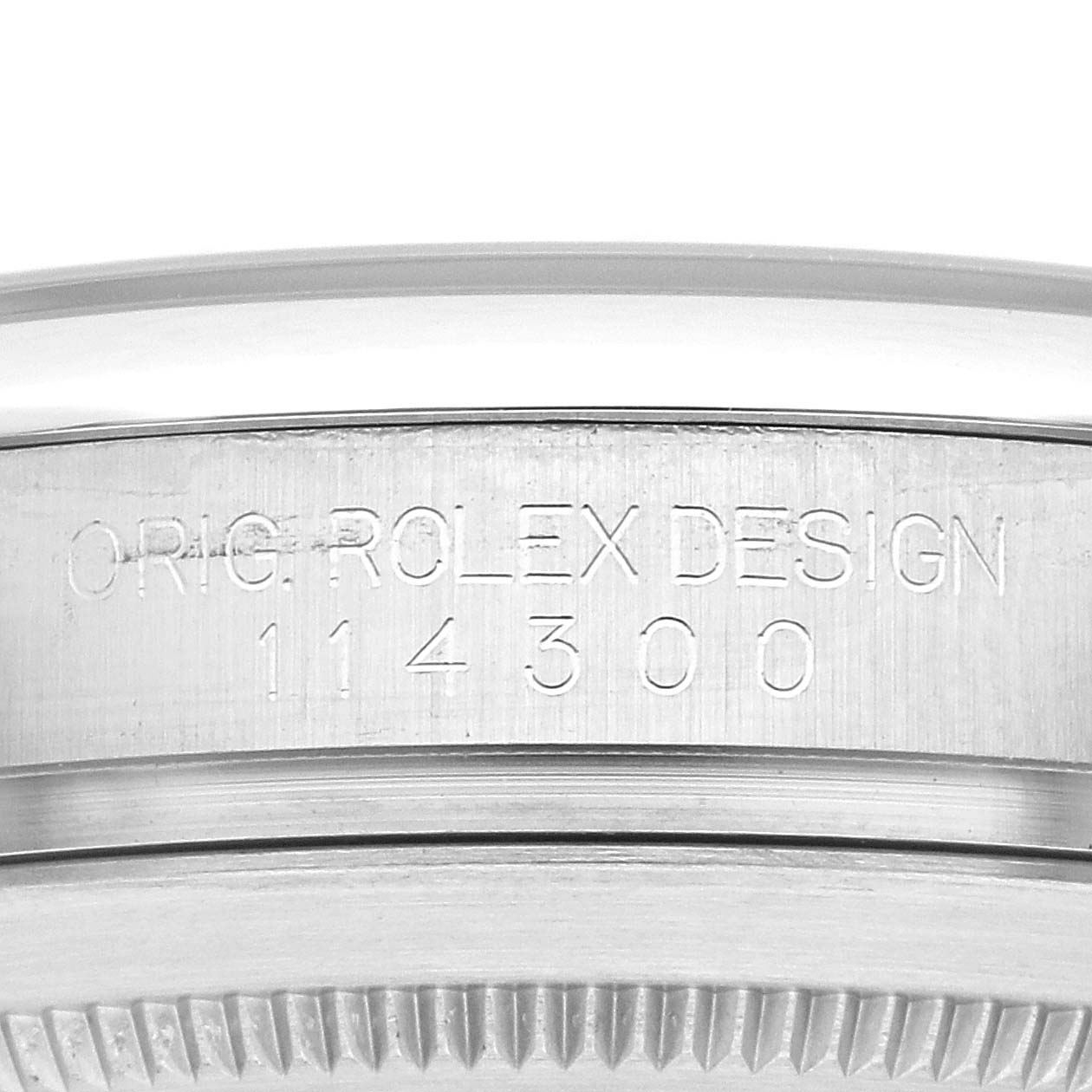 This image shows the engraved side of the Rolex Oyster Perpetual 114300 Men's Stainless Steel Blue Dial 114300 Men's Stainless Steel Blue Dial watch case, displaying the model number 114300.