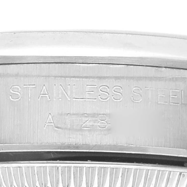 This close-up image displays the stainless steel engraving on the case back of a Rolex Oyster Perpetual 67180 Women's Stainless Steel Blue Dial 67180 Women's Stainless Steel Blue Dial watch.